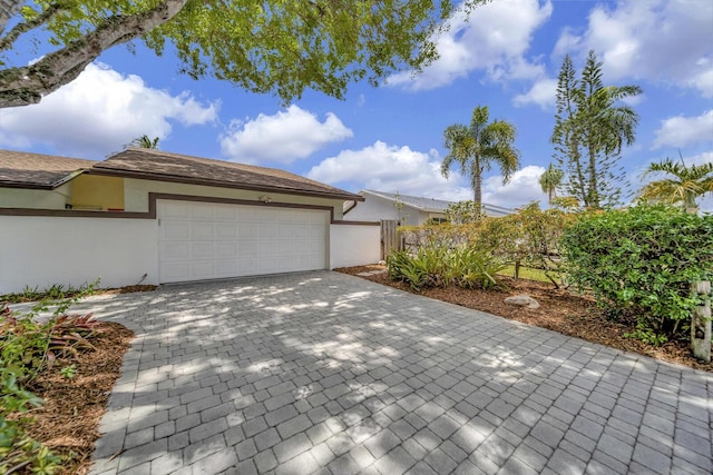 9152 Affirmed Ln, Boca Raton, FL 33496 - garage with decorative driveway and fence