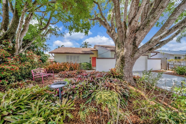 9152 Affirmed Ln, Boca Raton, FL 33496 - view of front of house with stucco siding, a garage, and concrete driveway