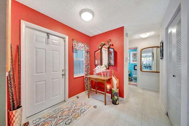 9152 Affirmed Ln, Boca Raton, FL 33496 - foyer entrance featuring baseboards and a textured ceiling