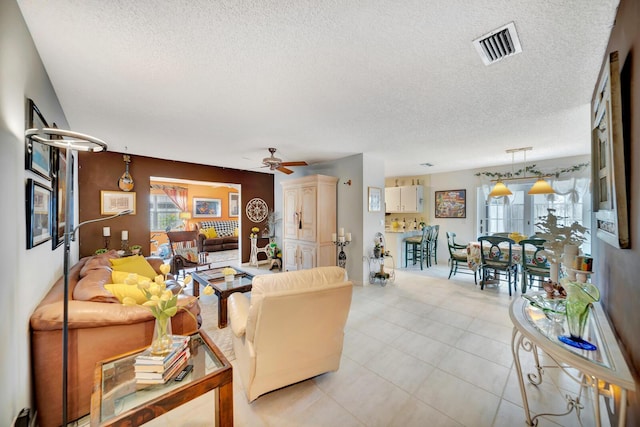 9152 Affirmed Ln, Boca Raton, FL 33496 - living room featuring a textured ceiling, a ceiling fan, and light tile patterned flooring