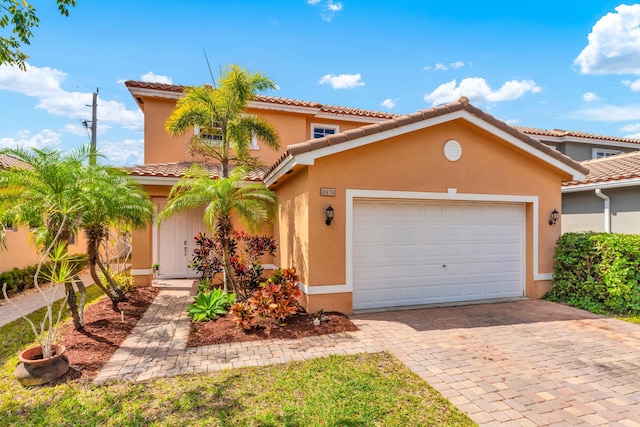 2478 SW Liberty St, Palm City, FL 34990 - mediterranean / spanish-style home featuring stucco siding, a tile roof, decorative driveway, and a garage