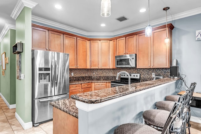 2478 SW Liberty St, Palm City, FL 34990 - kitchen featuring stainless steel appliances, dark stone counters, a peninsula, decorative light fixtures, and ornamental molding