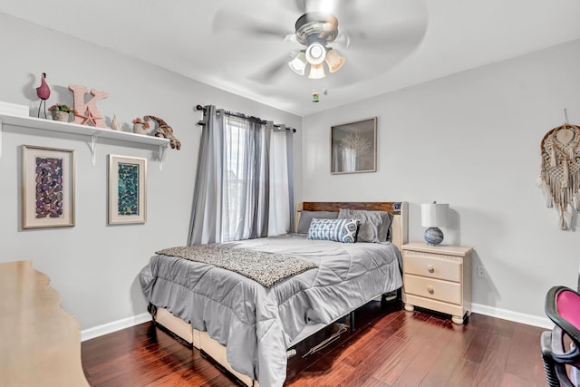 2478 SW Liberty St, Palm City, FL 34990 - bedroom with wood finished floors, baseboards, and a ceiling fan