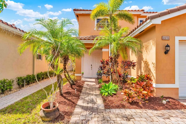 2478 SW Liberty St, Palm City, FL 34990 - entrance to property with a tiled roof and stucco siding