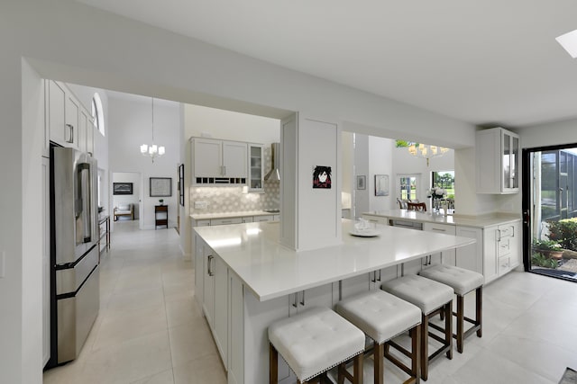 4054 SW Gleneagle Cir, Palm City, FL 34990 - kitchen with a chandelier, stainless steel refrigerator with ice dispenser, and glass insert cabinets