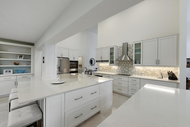 4054 SW Gleneagle Cir, Palm City, FL 34990 - kitchen with stainless steel appliances, wall chimney exhaust hood, decorative backsplash, light countertops, and glass insert cabinets