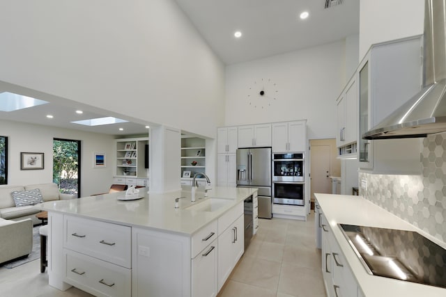 4054 SW Gleneagle Cir, Palm City, FL 34990 - kitchen with a sink, a towering ceiling, black appliances, wall chimney range hood, and open floor plan