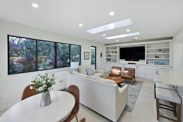4054 SW Gleneagle Cir, Palm City, FL 34990 - living area with a skylight, recessed lighting, baseboards, and built in shelves