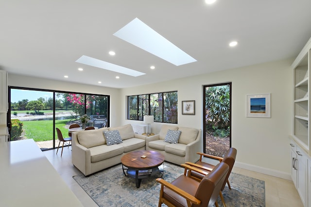 4054 SW Gleneagle Cir, Palm City, FL 34990 - living area featuring a skylight, recessed lighting, light tile patterned floors, and baseboards