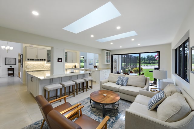 4054 SW Gleneagle Cir, Palm City, FL 34990 - living room featuring a skylight, recessed lighting, light tile patterned floors, and a chandelier