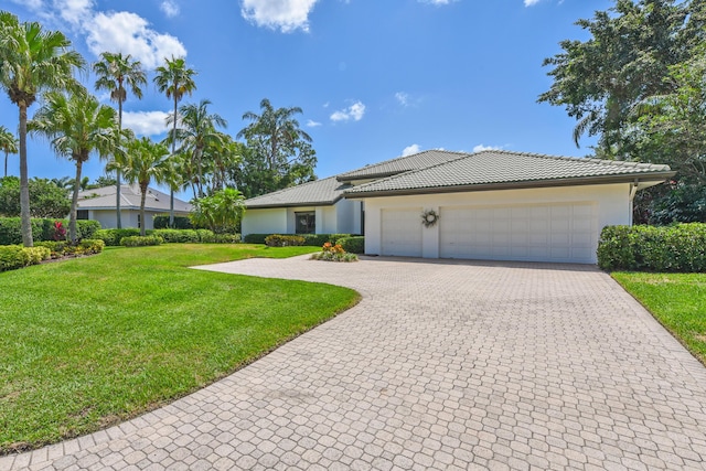4054 SW Gleneagle Cir, Palm City, FL 34990 - view of front of property with decorative driveway, a front yard, an attached garage, stucco siding, and a tile roof