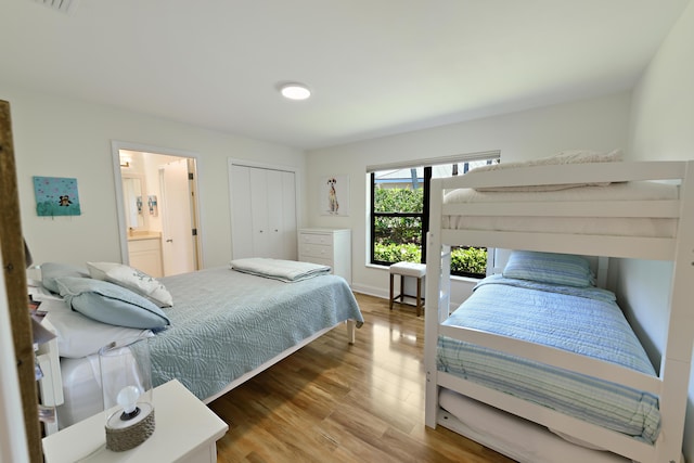 4054 SW Gleneagle Cir, Palm City, FL 34990 - bedroom with wood finished floors, a closet, and ensuite bathroom