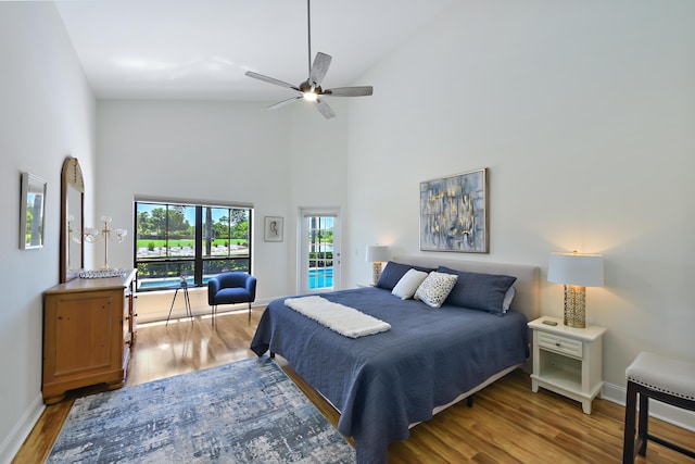 4054 SW Gleneagle Cir, Palm City, FL 34990 - bedroom with baseboards, high vaulted ceiling, wood finished floors, access to outside, and ceiling fan