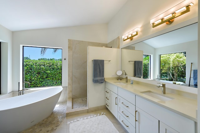 4054 SW Gleneagle Cir, Palm City, FL 34990 - bathroom featuring vaulted ceiling, double vanity, a walk in shower, a freestanding bath, and tile patterned flooring