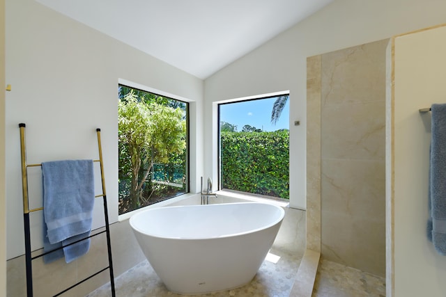 4054 SW Gleneagle Cir, Palm City, FL 34990 - full bathroom featuring vaulted ceiling, a soaking tub, and tile patterned flooring