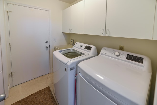 4054 SW Gleneagle Cir, Palm City, FL 34990 - clothes washing area featuring washing machine and clothes dryer, cabinet space, and light tile patterned floors