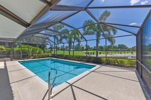 4054 SW Gleneagle Cir, Palm City, FL 34990 - outdoor pool featuring a patio, a water view, and glass enclosure