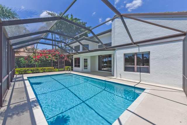 4054 SW Gleneagle Cir, Palm City, FL 34990 - swimming pool featuring a patio and glass enclosure