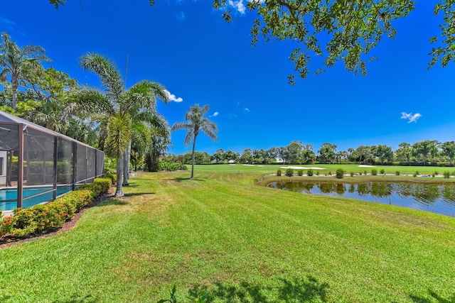 4054 SW Gleneagle Cir, Palm City, FL 34990 - view of green lawn with a water view, glass enclosure, and an outdoor pool