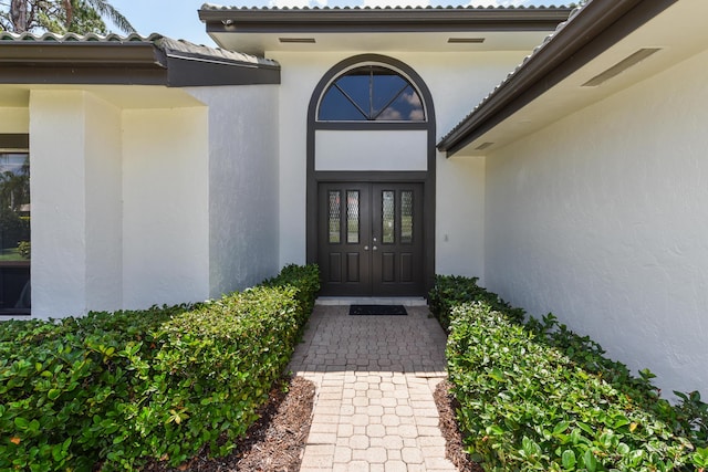 4054 SW Gleneagle Cir, Palm City, FL 34990 - doorway to property featuring stucco siding