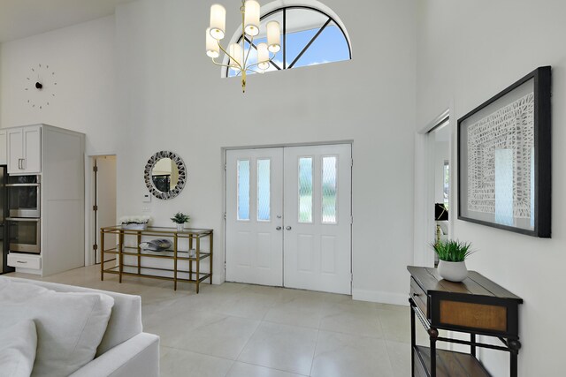 4054 SW Gleneagle Cir, Palm City, FL 34990 - foyer with a high ceiling, a chandelier, and light tile patterned flooring