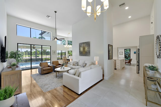4054 SW Gleneagle Cir, Palm City, FL 34990 - living area featuring a high ceiling, a chandelier, ceiling fan, baseboards, and recessed lighting