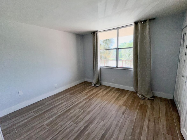 14527 Bonaire Blvd Unit 306, Delray Beach, FL 33446 - empty room featuring wood finished floors and baseboards