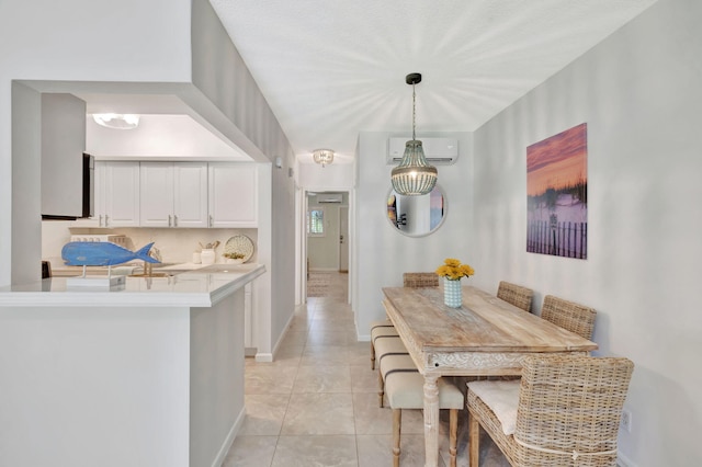 dining space featuring a wall unit AC, baseboards, and light tile patterned flooring