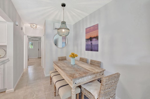 dining space featuring light tile patterned floors and baseboards