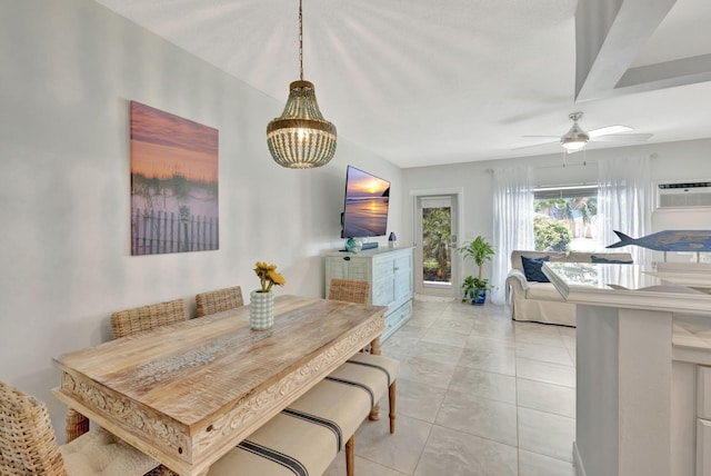 dining space with a chandelier, light tile patterned floors, and a ceiling fan