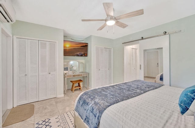 tiled bedroom featuring multiple closets, a wall mounted air conditioner, and ceiling fan