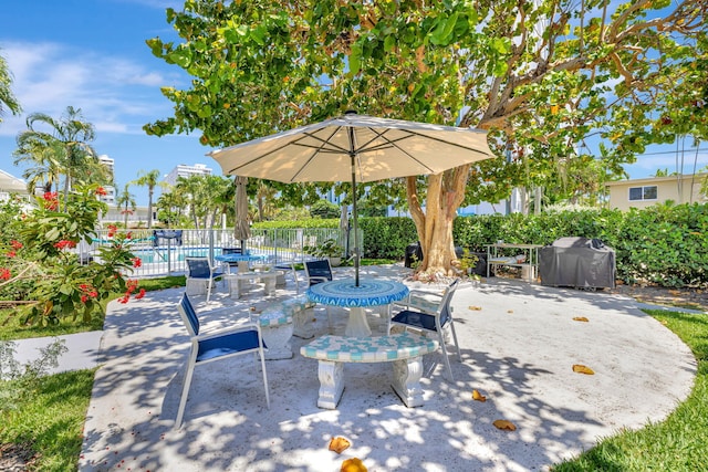 view of patio with a grill and fence