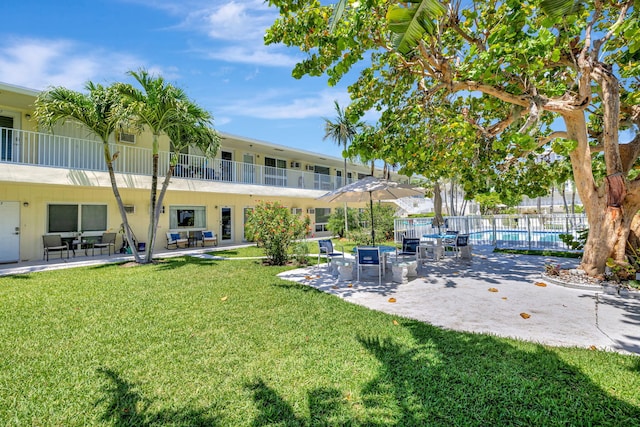 view of community featuring a pool and a patio