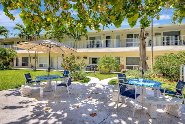 view of patio / terrace featuring outdoor dining space and a balcony