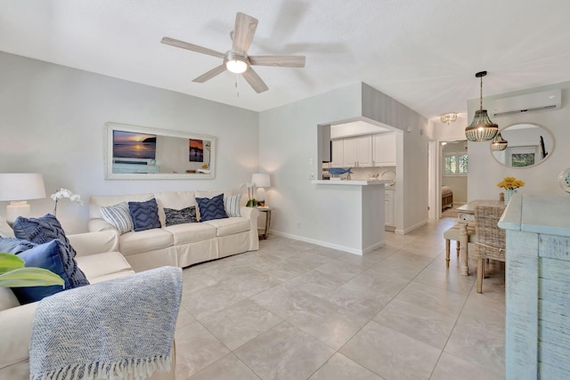 living area featuring an AC wall unit, ceiling fan, and baseboards