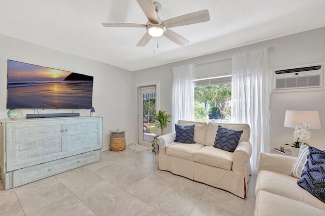 tiled living room with an AC wall unit, a ceiling fan, and a textured ceiling