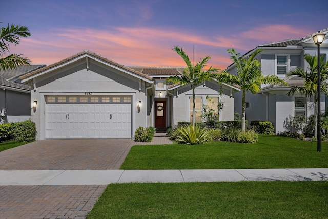 4641 Woodland Way, Westlake, FL 33470 - single story home featuring decorative driveway, stucco siding, an attached garage, a tile roof, and a front lawn