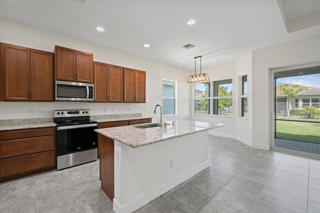 4641 Woodland Way, Westlake, FL 33470 - kitchen featuring stainless steel appliances, a sink, light stone counters, a kitchen island with sink, and recessed lighting