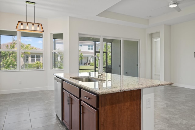 4641 Woodland Way, Westlake, FL 33470 - kitchen with a sink, baseboards, stainless steel dishwasher, light stone counters, and pendant lighting
