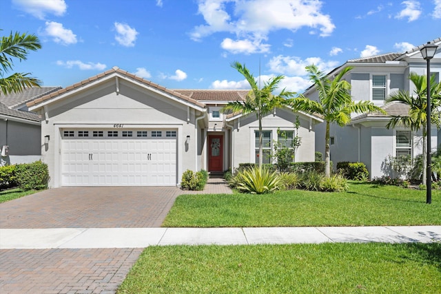 4641 Woodland Way, Westlake, FL 33470 - ranch-style home with a tiled roof, stucco siding, decorative driveway, an attached garage, and a front lawn