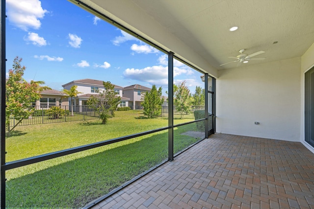 4641 Woodland Way, Westlake, FL 33470 - unfurnished sunroom featuring a ceiling fan and a residential view