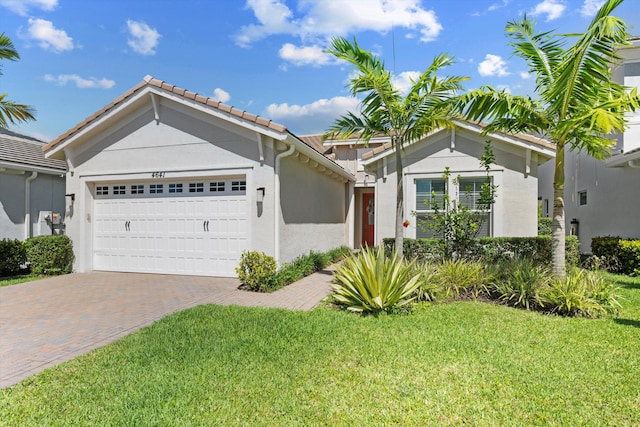 4641 Woodland Way, Westlake, FL 33470 - ranch-style house featuring a garage, decorative driveway, stucco siding, a front lawn, and a tiled roof