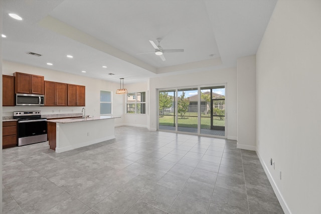 4641 Woodland Way, Westlake, FL 33470 - kitchen with appliances with stainless steel finishes, open floor plan, ceiling fan, a sink, and baseboards