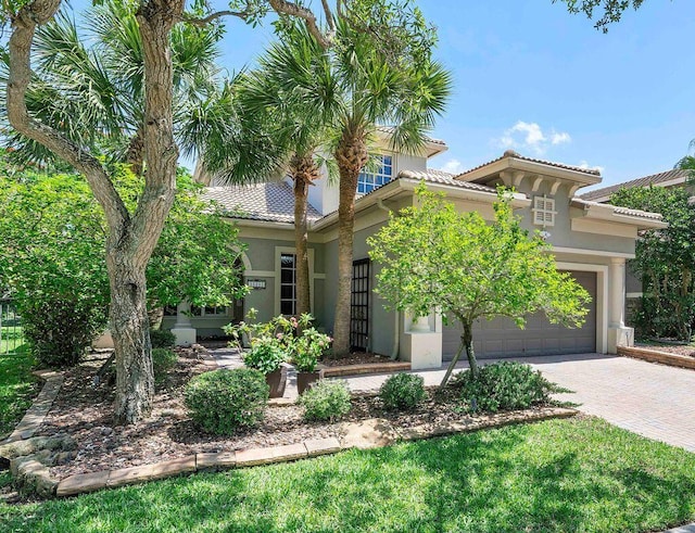 12341 NW 78th Mnr, Parkland, FL 33076 - view of front facade with stucco siding, an attached garage, driveway, and a tile roof