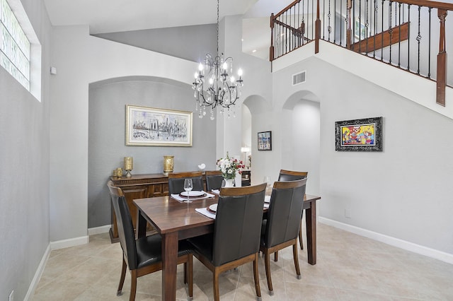 12341 NW 78th Mnr, Parkland, FL 33076 - dining area featuring arched walkways, high vaulted ceiling, light tile patterned floors, a chandelier, and baseboards