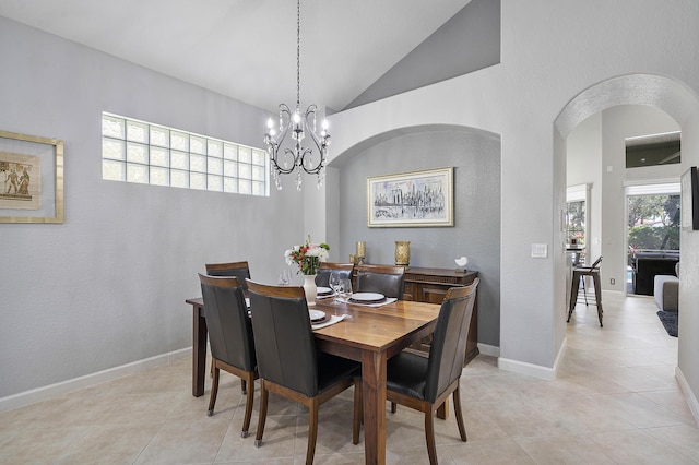12341 NW 78th Mnr, Parkland, FL 33076 - dining area with a chandelier, light tile patterned floors, arched walkways, baseboards, and high vaulted ceiling