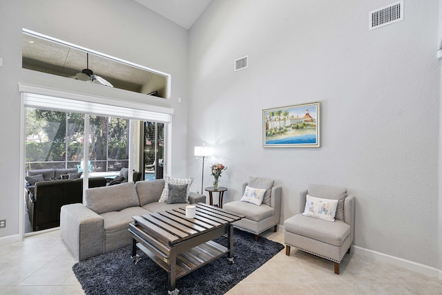 12341 NW 78th Mnr, Parkland, FL 33076 - living room featuring light tile patterned flooring, a towering ceiling, and baseboards