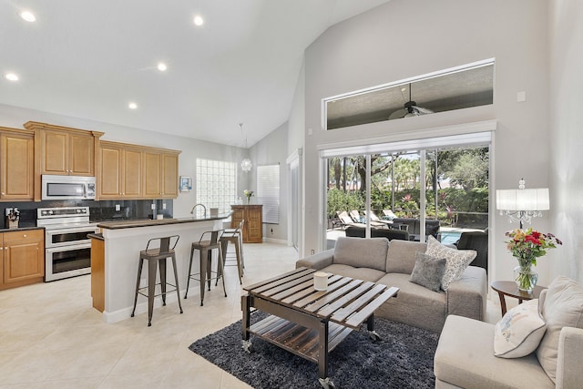 12341 NW 78th Mnr, Parkland, FL 33076 - living area featuring high vaulted ceiling, light tile patterned floors, recessed lighting, and baseboards