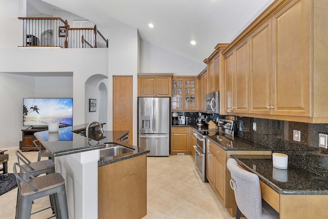 12341 NW 78th Mnr, Parkland, FL 33076 - kitchen featuring appliances with stainless steel finishes, a sink, backsplash, a kitchen bar, and recessed lighting