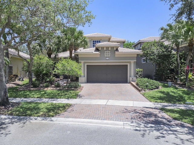12341 NW 78th Mnr, Parkland, FL 33076 - mediterranean / spanish-style house featuring decorative driveway, stucco siding, and a tile roof